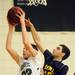 Greenhills sophomore Abe Estenson reaches for a rebound around Eastern Washtenaw Multicultural senior Yasser Farha during the first half at Greenhills on Thursday. Melanie Maxwell I AnnArbor.com